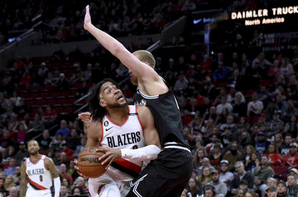 Portland Trail Blazers forward Trendon Watford, left, drives to the basket on Los Angeles Clippers center Mason Plumlee during the first half of an NBA basketball game in Portland, Ore., Sunday, March 19, 2023. (AP Photo/Steve Dykes)