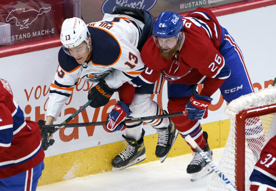 Montreal Canadiens defenseman Jeff Petry (26) blocks Edmonton Oilers' Jesse Puljujarvi during the second period of an NHL hockey game, Tuesday, March 30, 2021 in Montreal. (Paul Chiasson/The Canadian Press via AP)