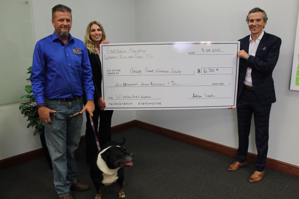 The Gulf Coast Humane Society was presented with a check from Goldstein, Buckley, Cechman, Rice & Purtz.