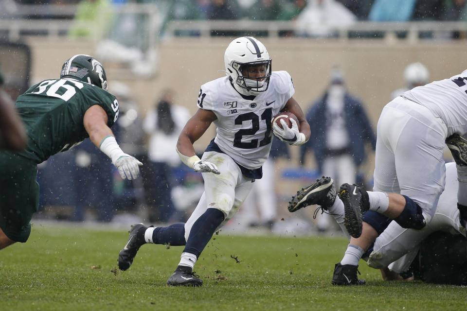 Penn State running back Noah Cain (21) rushes against Michigan State Jacub Pansiuk, left, during the first quarter of an NCAA college football game, Saturday, Oct. 26, 2019, in East Lansing, Mich. Penn State won 28-7. (AP Photo/Al Goldis)