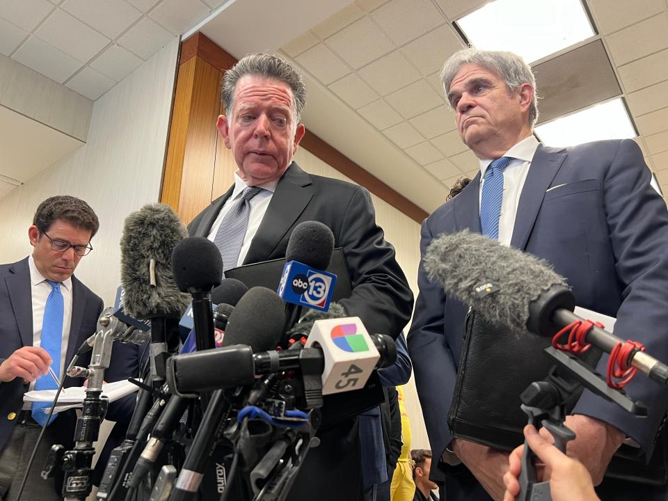 Texas Attorney General Ken Paxton's defense attorneys Dan Cogdell, left, and Philip Hilder speak to the media outside the courtroom in Houston on Tuesday after Paxton agreed to a deal to resolve securities fraud charges against him.