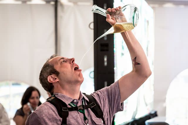 <p>Huge Galdones</p> Photographer Ken Goodman drinks from a porron