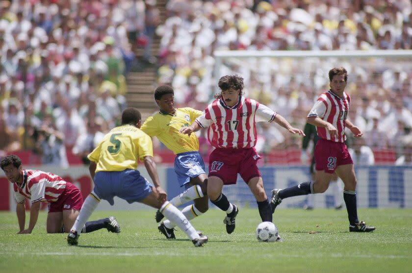 United States defender Marcelo Balboa, right, duels for the ball with Brazilians Mazinho (17) and Mauro Silva (5) during the second round World Cup soccer match Brazil Vs. United States, Monday, July 4, 1994 in Stanford Stadium, Stanford, Calif. (AP Photo/Eric Draper)