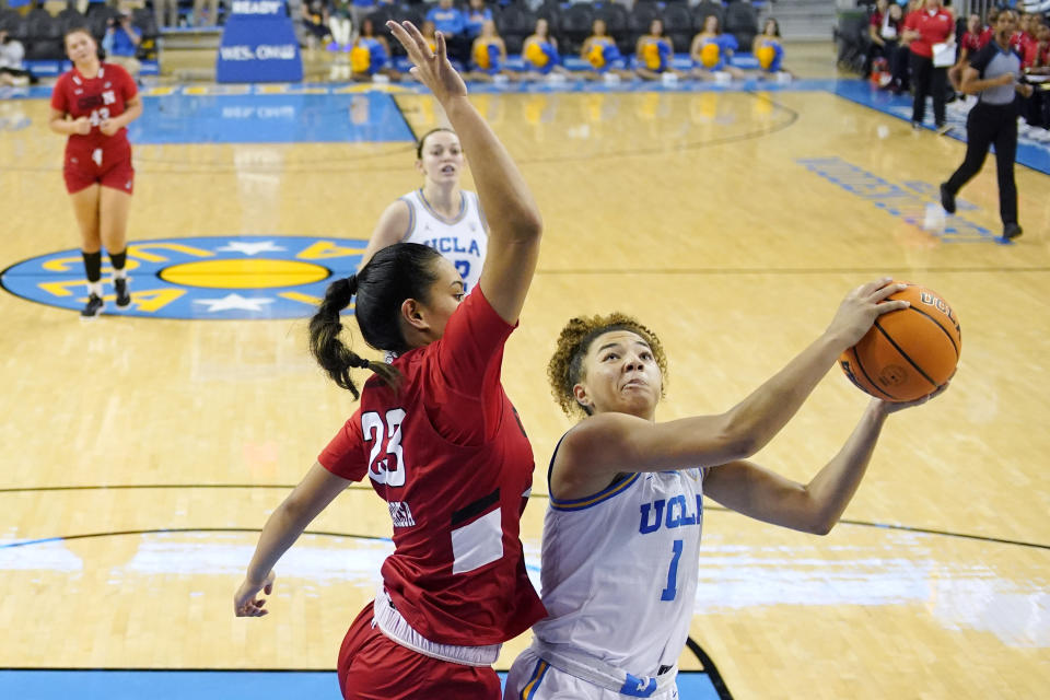 UCLA guard Kiki Rice, right, shoots as Cal State Northridge forward Talo Li-Uperesa defends during the second half of an NCAA college basketball game Thursday, Dec. 7, 2023, in Los Angeles. (AP Photo/Mark J. Terrill)
