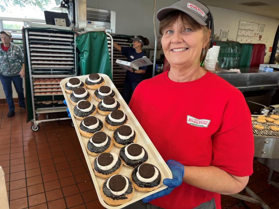 Angie Wilhelm holds up a tray of Total Eclipse doughnuts at the Melbourne Krispy Kreme. They have been selling total eclipse donuts all weekend. Yummy!