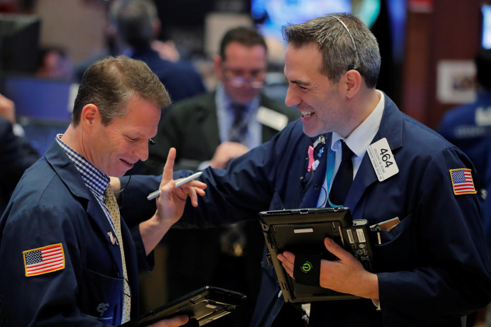 Traders laugh as they work on the floor of the New York Stock Exchange shortly after the opening bell in New York, U.S., January 5, 2018.  REUTERS/Lucas Jackson