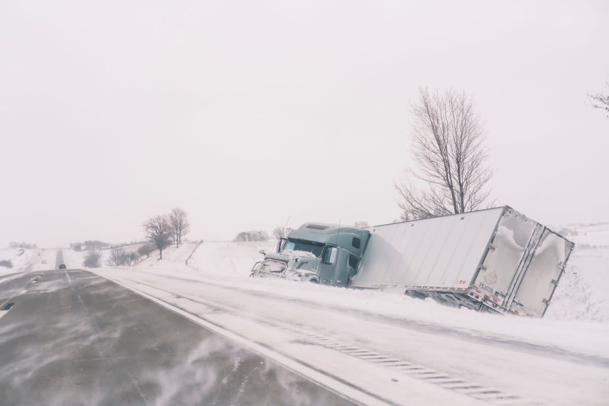 An crashed semi truck sits abandoned along Interstate 80 in central Iowa on Saturday, Jan. 13