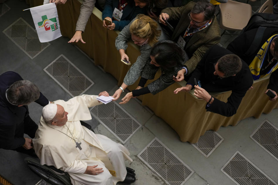 Pope Francis arrives to meet the members of the 2023 World Youth Day organizing committee, in the Pope Paul VI hall at the Vatican, Thursday, Nov. 30, 2023. (AP Photo/Andrew Medichini)