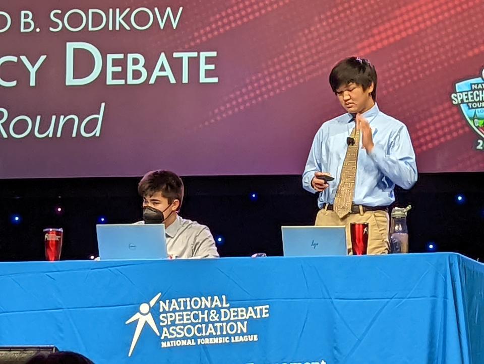 Jinyoon Park cross examines the competition in the policy debate championship round of the National Speech and Debate Association Tournament on June 17.