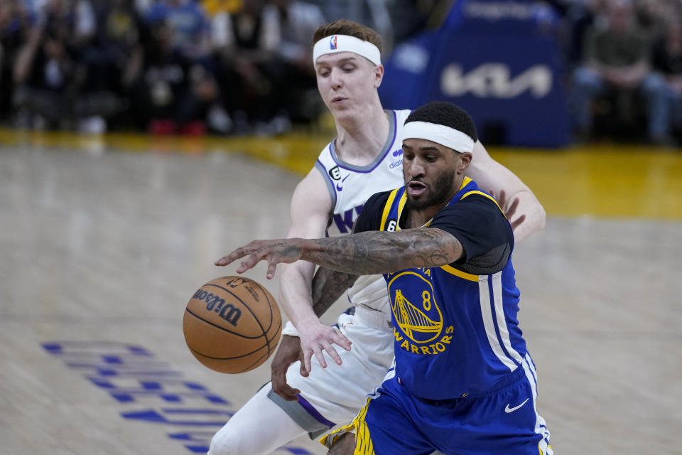 Sacramento Kings guard Kevin Huerter, left, and Golden State Warriors guard Gary Payton II (8) compete for possession of the ball during the first half of Game 6 of a first-round NBA basketball playoff series in San Francisco, Friday, April 28, 2023. (AP Photo/Godofredo A. Vásquez)