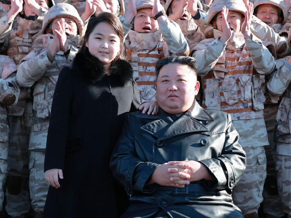 Kim Jong-un, accompanied by his daughter Kim Ju Ae, attends a meeting and photo session with the officials, scientists, technicians, and soldiers who contributed to the successful test launch of Hwasongpho-17