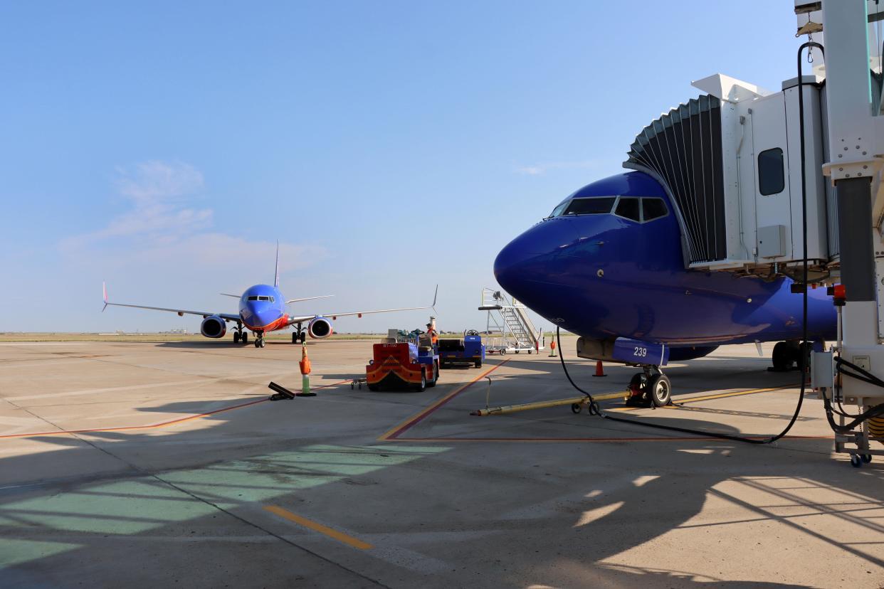 Ground crews are ready for a Southwest Airlines flight to finish taxiing at Rick Husband Amarillo International Airport.