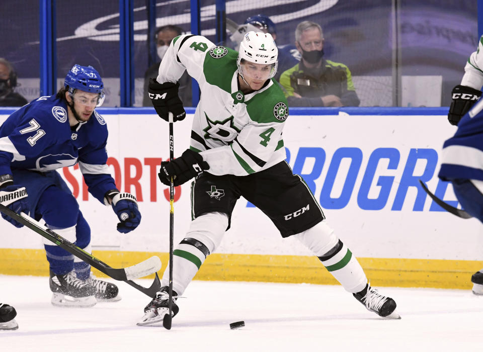 Dallas Stars defenseman Miro Heiskanen (4) handles the puck during the first period of the team's NHL hockey game against the Tampa Bay Lightning on Friday, May 7, 2021, in Tampa, Fla. (AP Photo/Jason Behnken)