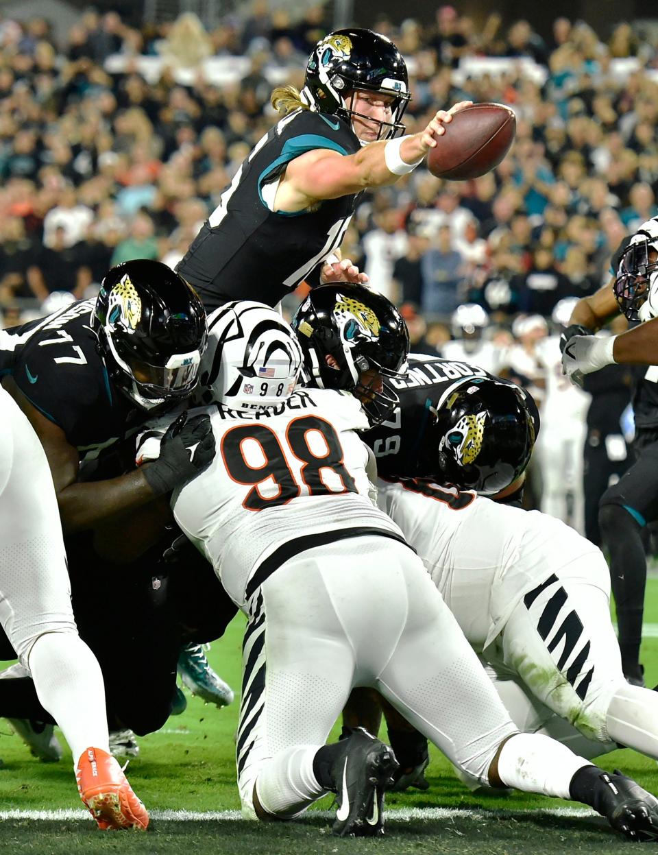 Jacksonville Jaguars quarterback Trevor Lawrence (16), seen here stretching the ball over the goal line for a touchdown against the Cincinnati Bengals, has to do a better job protecting the ball if he wants to become elite at his position. He leads the NFL with 60 turnovers the last three seasons.
