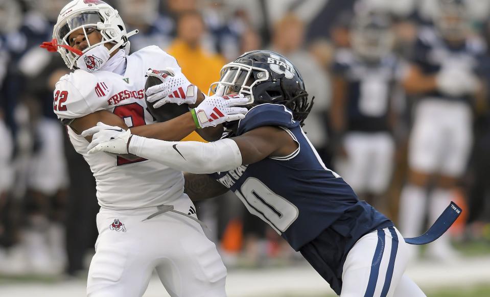 Fresno State running back Malik Sherrod (22) gets tackled by Utah State cornerback Jaiden Francois (10) during the first half of an NCAA college football game Friday, Oct. 13, 2023, in Logan, Utah. | Eli Lucero/The Herald Journal via AP