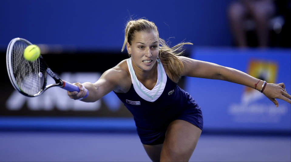 Dominika Cibulkova of Slovakia makes a forehand return to Li Na of China during their women's singles final at the Australian Open tennis championship in Melbourne, Australia, Saturday, Jan. 25, 2014.(AP Photo/Rick Rycroft)