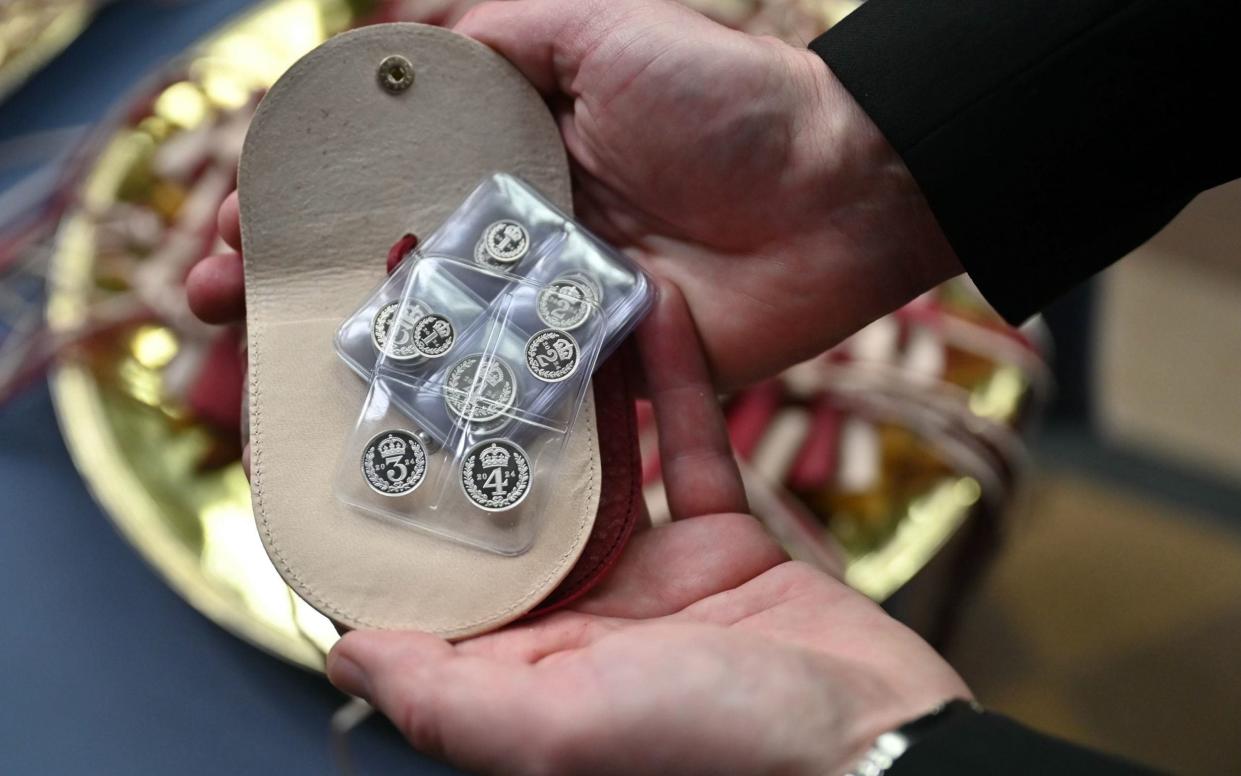 White purses contain a set of specially minted silver Maundy coins