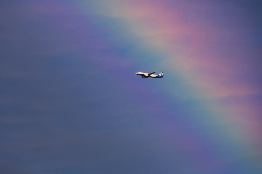 An airplane flies through a rainbow on August 18, 2021, in Chongqing, China. (Photo by Chen Liang/VCG via Getty Images)