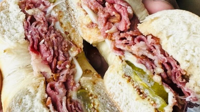 pastrami, cheese, pickles on bagel