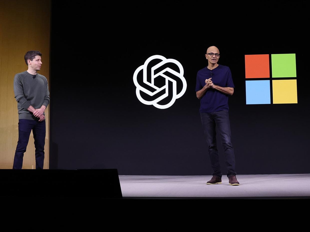 Microsoft CEO Satya Nadella (R) speaks as OpenAI CEO Sam Altman (L) looks on during the OpenAI DevDay event on November 06, 2023 in San Francisco, California.