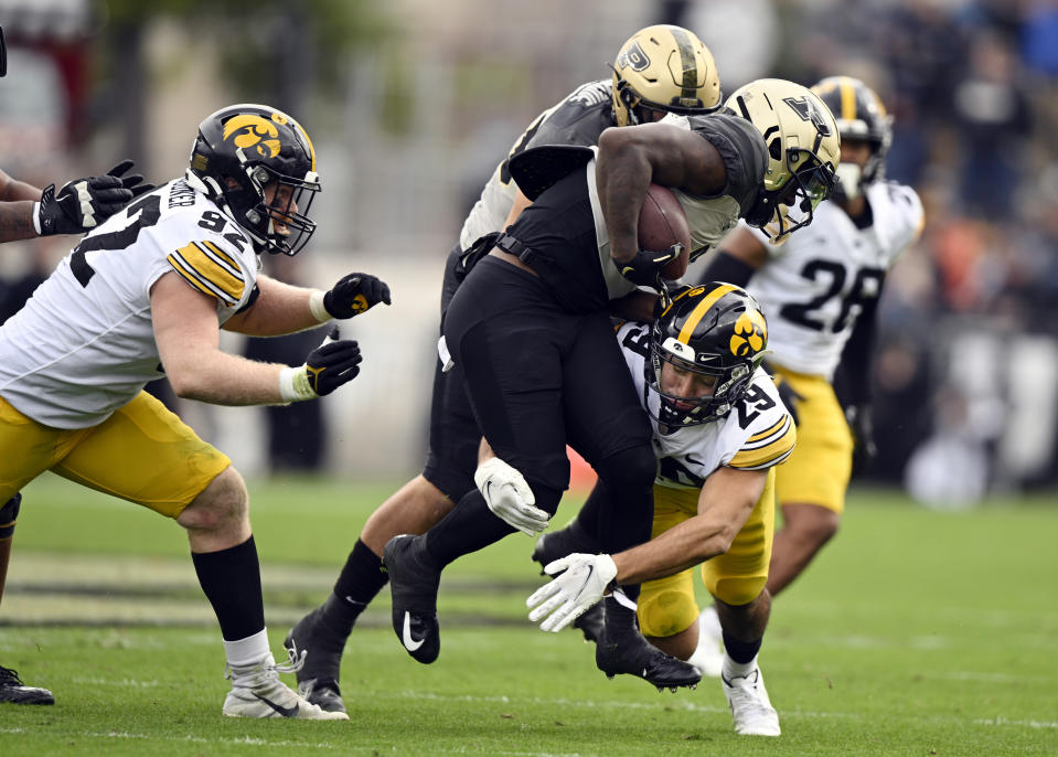 Purdue wide receiver Deion Burks (4) is tackled by Iowa defensive back Sebastian Castro (29) during the second half of an NCAA college football game, Saturday, Nov. 5, 2022, in West Lafayette, Ind. (AP Photo/Marc Lebryk)