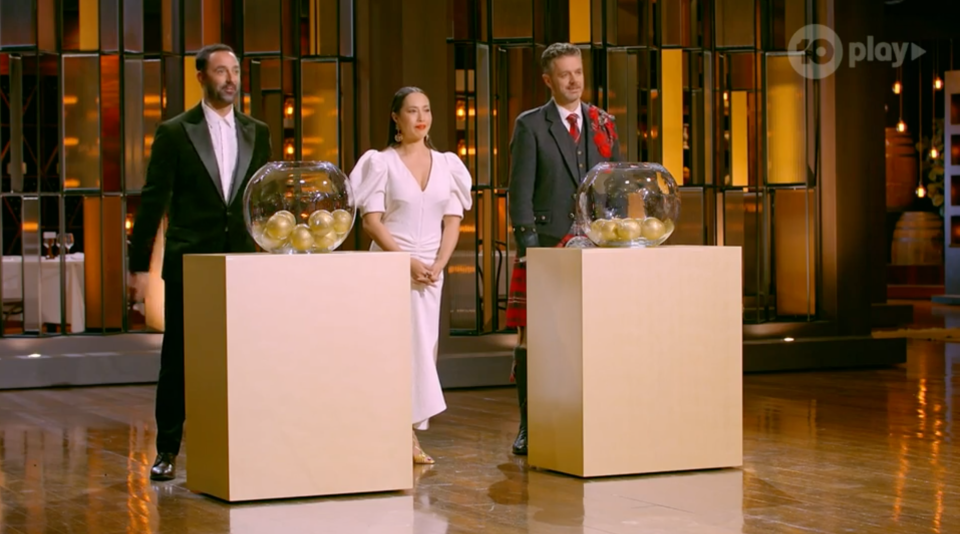 MasterChef judges with two bowls of golden balls.