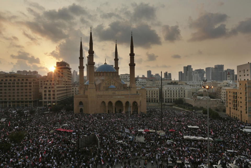 Anti-government protesters shout slogans during a protest in Beirut, Lebanon, Sunday, Oct. 20, 2019. Tens of thousands of Lebanese protesters of all ages gathered Sunday in major cities and towns nationwide, with each hour bringing hundreds more people to the streets for the largest anti-government protests yet in four days of demonstrations. (AP Photo/Hassan Ammar)