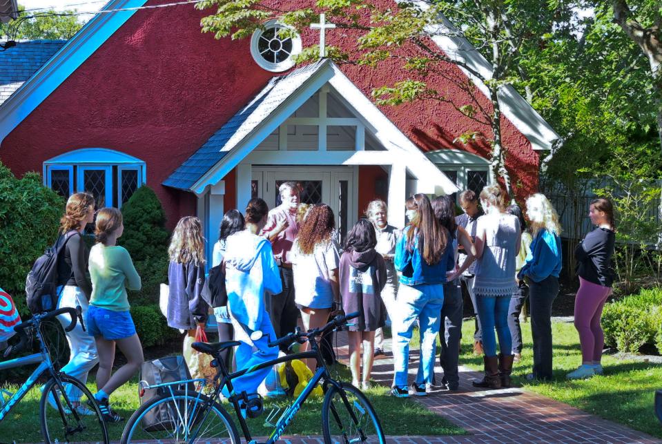 Members of the Martha's Vineyard High School advanced Spanish class gather around volunteers at St. Andrews Episcopal Church in Edgartown to prepare to help Spanish-speaking migrants staying there.