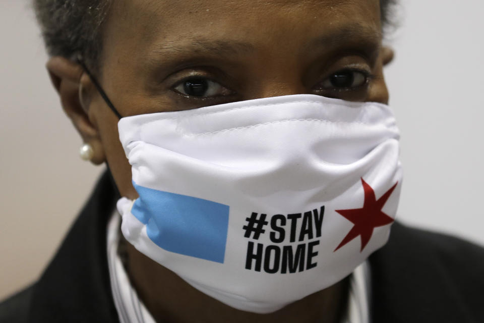 Chicago Mayor Lori Lightfoot wears a mask as she attends a news conference in Hall A of the COVID-19 alternate site at McCormick Place in Chicago, Friday, April 10, 2020. The "alternative care facility" is designed to relieve pressure on city hospitals from rapidly mounting COVID-19 cases. (AP Photo/Nam Y. Huh)