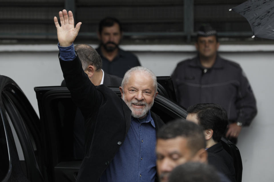 Former Brazilian President Luiz Inacio Lula da Silva, who is running for president again, waves upon his arrival to a polling station to vote in the general election in Sao Paulo, Brazil, Sunday, Oct. 2, 2022. (AP Photo/Marcelo Chello)