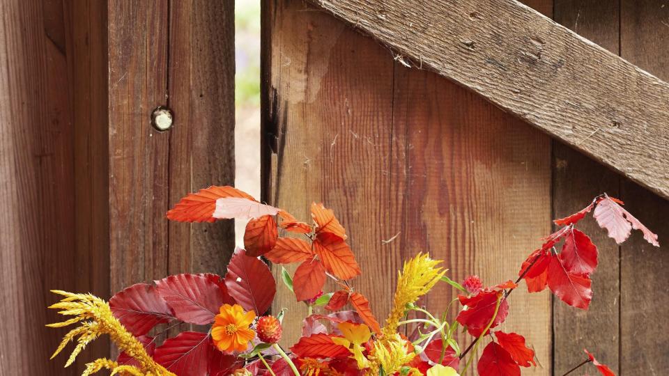 seasonal flower bouquet arrangement in a copper pitcher