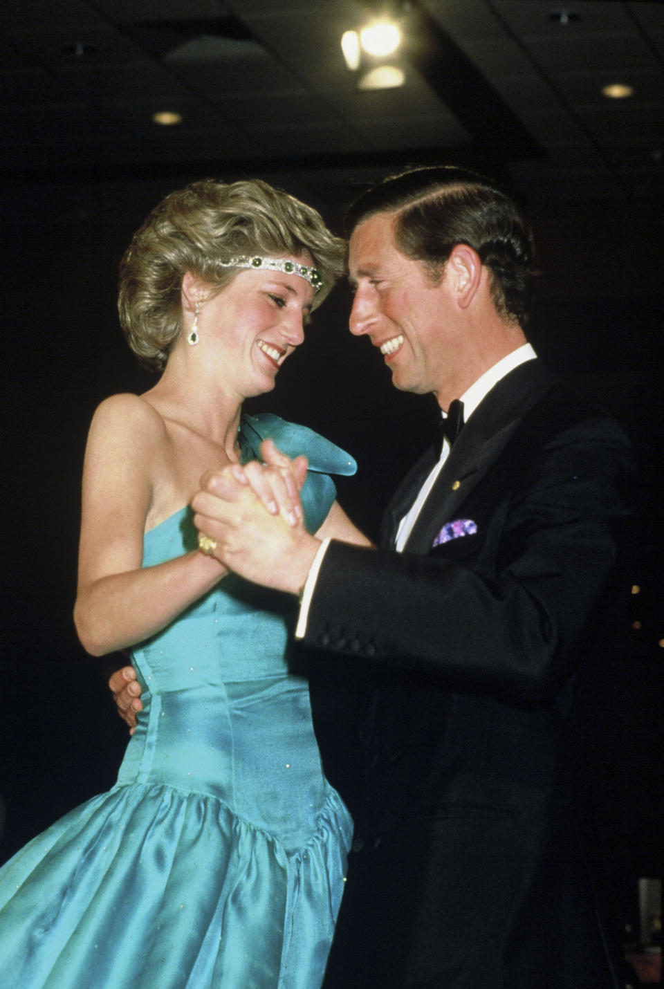 MELBOURNE, AUSTRALIA - OCTOBER 31: Prince Charles, Prince of Wales and Diana, Princess of Wales, wearing a green satin evening dress designed by David and Elizabeth Emanuel and an emerald necklace as a headband, dance together during a gala dinner dance at the Southern Cross Hotel on October 31, 1985 in Melbourne, Australia. (Photo by Anwar Hussein/Getty Images)