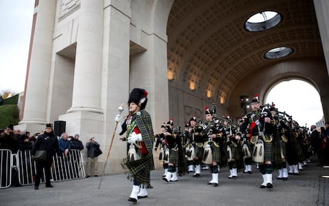 The Ypres and Surrey Pipes Marching Band march during an Armistice ceremony at the Menin Gate - Credit: AP Photo/Virginia Mayo