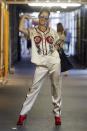 <p>Going for the Gucci: Celine donned a matching silk outfit and red patent leather boots by the brand in Paris. <br></p>