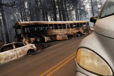 An abandoned and burned school bus is seen on Skyway during the Camp Fire in Paradise, California, U.S. November 9, 2018. REUTERS/Stephen Lam