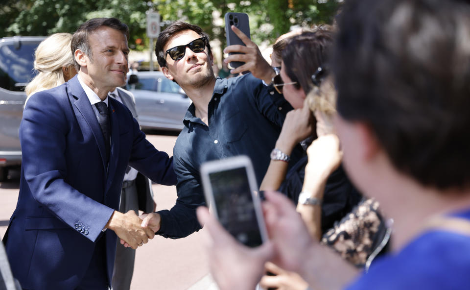 France's President Emmanuel Macron meets residents after voting in the first round of French parliamentary election in Le Touquet, northern France, Sunday June 12, 2022. French voters are choosing lawmakers in a parliamentary election as President Emmanuel Macron seeks to secure his majority while under growing threat from a leftist coalition. More than 6,000 candidates, ranging in age from 18 to 92, are running for 577 seats in the National Assembly in the first round of the election. (Ludovic Marin, Pool via AP)