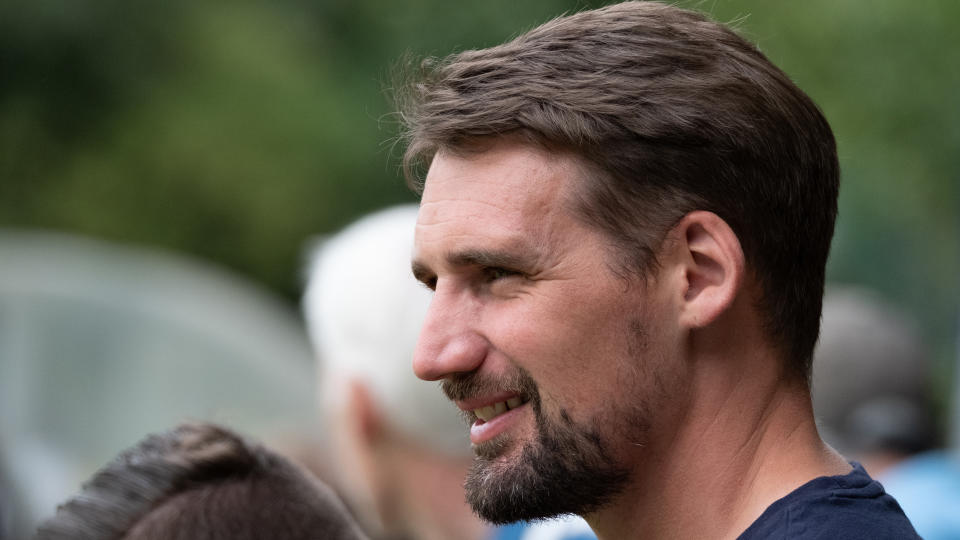 A man's face on the sidelines of a football match