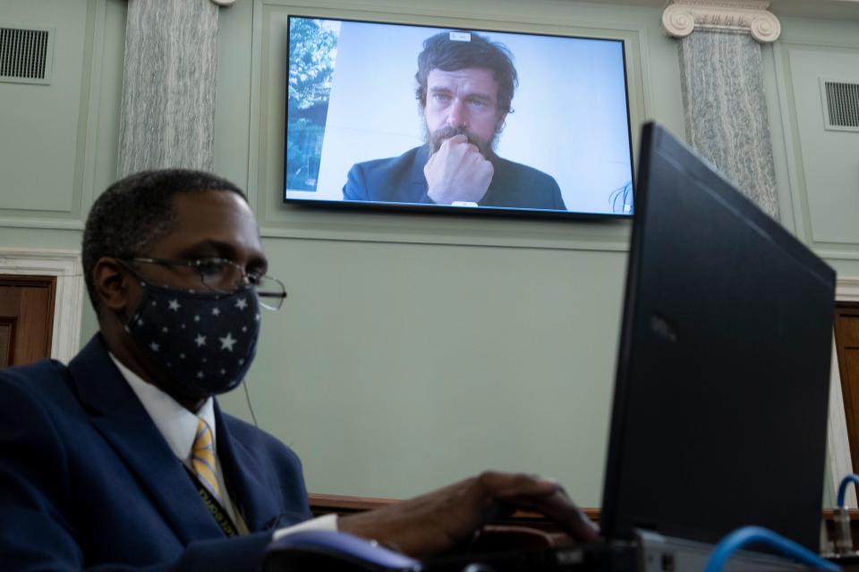 Twitter CEO Jack Dorsey appears on a monitor behind a stenographer as he testifies remotely during the Senate Commerce, Science, and Transportation Committee hearing "Does Section 230's Sweeping Immunity Enable Big Tech Bad Behavior?" on Oct. 28.