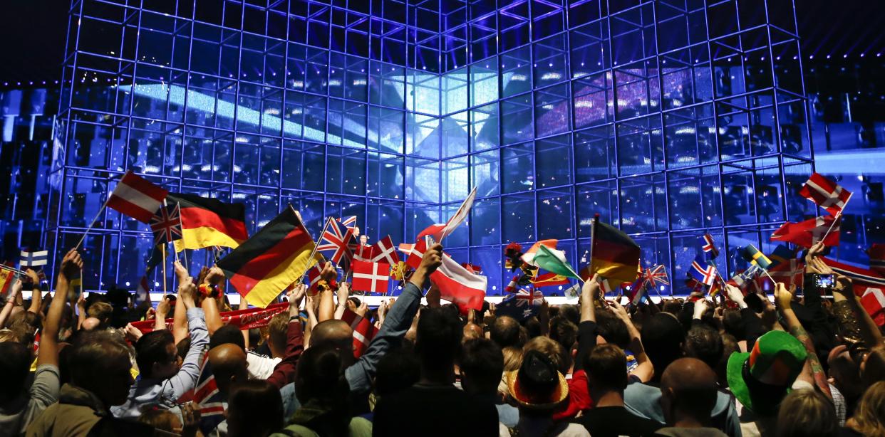 Flags are waved ahead of the final of the Eurovision Song Contest in the B&W Halls in Copenhagen, Denmark, Saturday, May 10, 2014. (AP Photo/Frank Augstein)