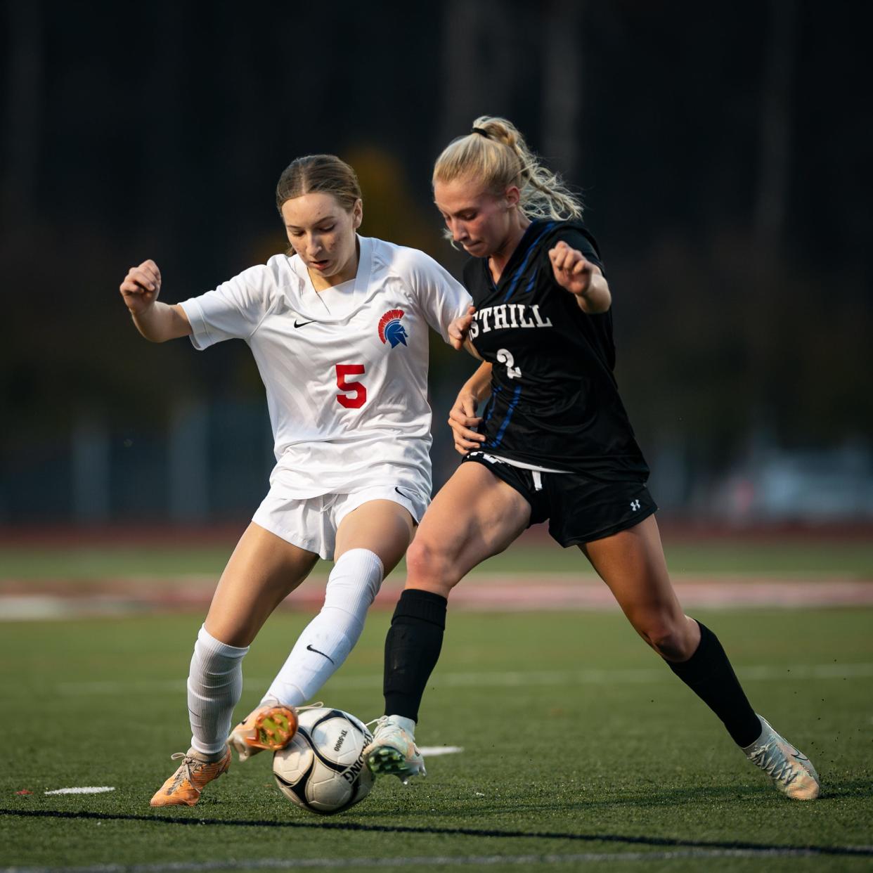 New Hartford's Ashlee Fisher and Westhill's Elle Herrera battle for possession during Friday's championship match in Cortland.