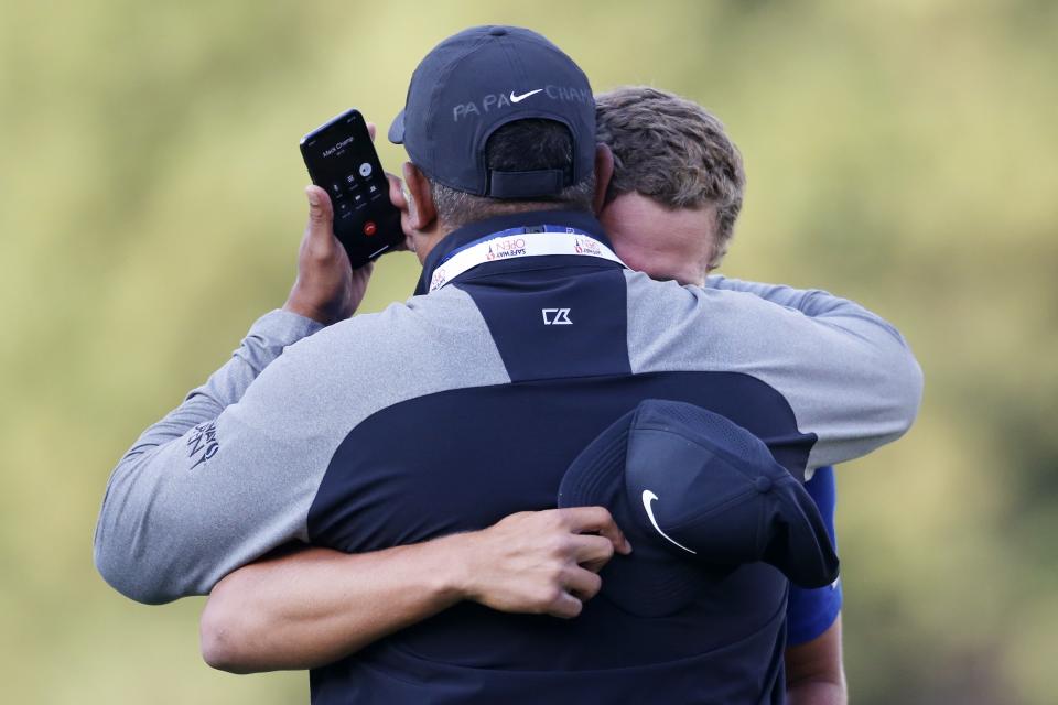 NAPA, CALIFORNIA - SEPTEMBER 29: Cameron Champ hugs his father, Jeff Champ, while on the phone with his grandfather after winning the final round of the Safeway Open at the Silverado Resort on September 29, 2019 in Napa, California. (Photo by Jonathan Ferrey/Getty Images)