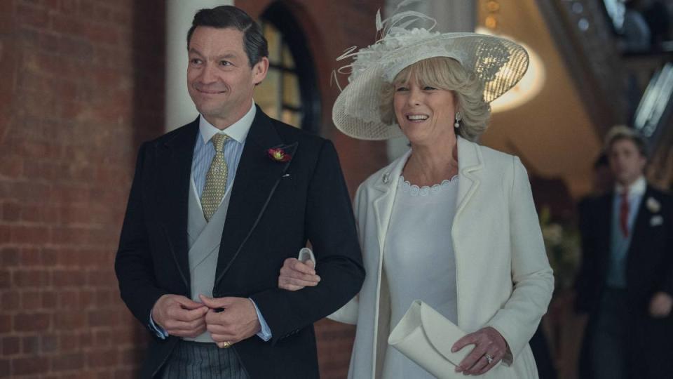 Man and woman walking arm in arm, smiling 