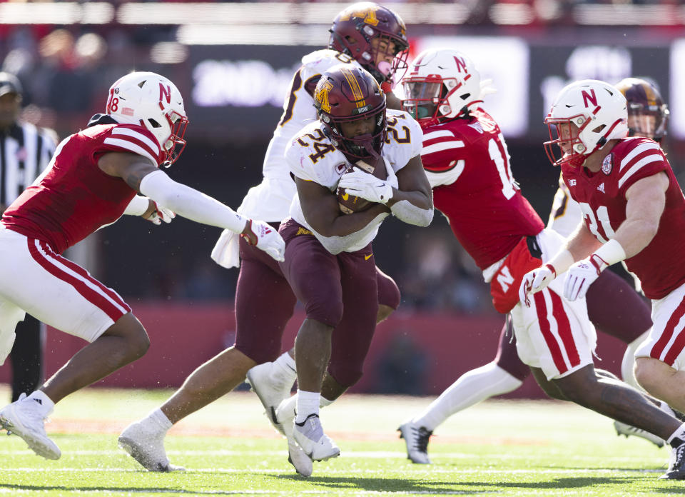 Minnesota's Mohamed Ibrahim, center, carries the ball as Nebraska's Myles Farmer, left, and Chris Kolarevic close in during the second half of an NCAA college football game Saturday, Nov. 5, 2022, in Lincoln, Neb. Ibrahim rushed for 128 yards and two touchdowns during Minnesota's 20-13 victory. (AP Photo/Rebecca S. Gratz)