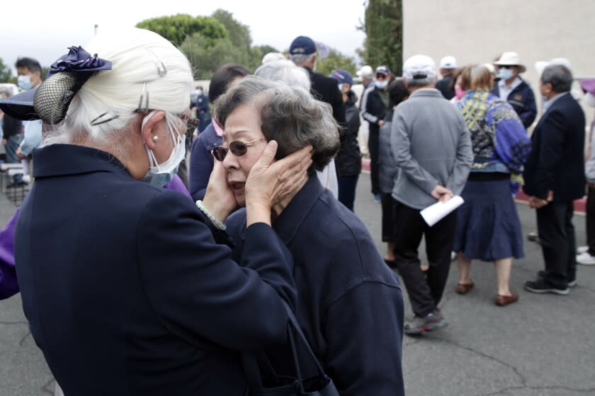 Jenny Wan-Chen Lo, from Buddhist Tzu Chi Foundation, left, comforts Sunny Chen at a press conference held at Geneva Presbyterian Church. Chen is one of the survivors of the shooting that took place at Geneva Presbyterian Church