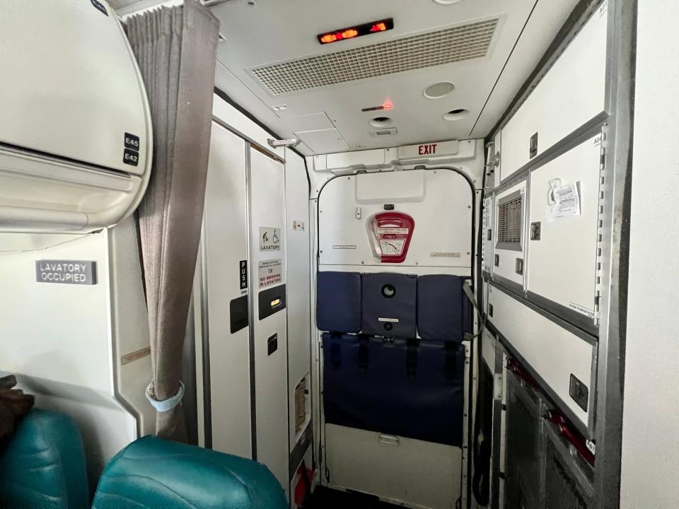 Door to bathroom in back of Hawaiian Airlines airplane