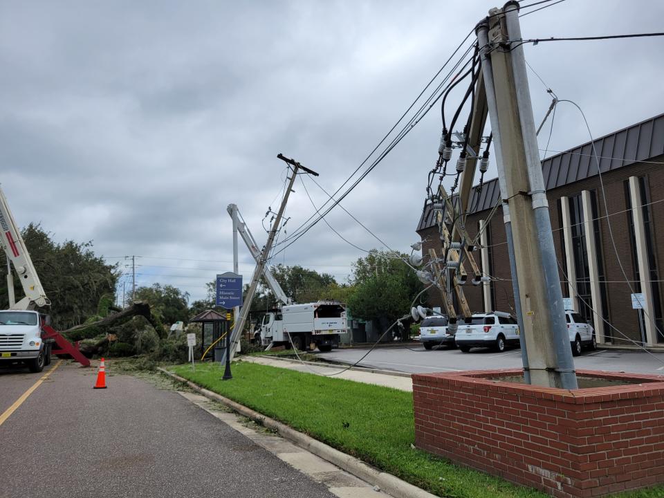 Wrecked power poles and a toppled oak tree on East Church Street in Bartow testify to the damaging winds of Hurricane Ian.