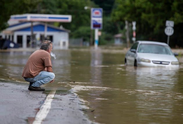 Van Jackson checks on his dog, Jack, who was stranded at a church by flood waters along Right Beaver Creek, following a day of heavy rain in in Garrett, Kentucky, on July 28. Jackson owns an auto parts store in town and said he doesn't have flood insurance to cover his loss. (Photo: Pat McDonogh/USA TODAY NETWORK/REUTERS)