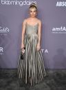 <p>Sienna stayed true to her boho chic style in a striped Dior gown paired with a hairband and updo. <em>[Photo: Getty]</em> </p>