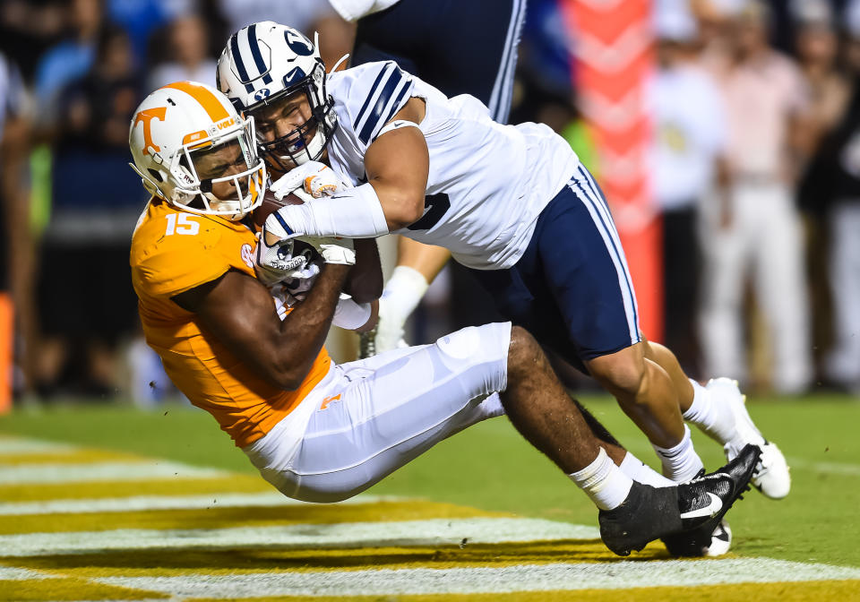 Tennessee Volunteers wide receiver Jauan Jennings (15) catches a pass while being guarded by Brigham Young Cougars linebacker Chaz Ah You (3) on Saturday. (Getty)