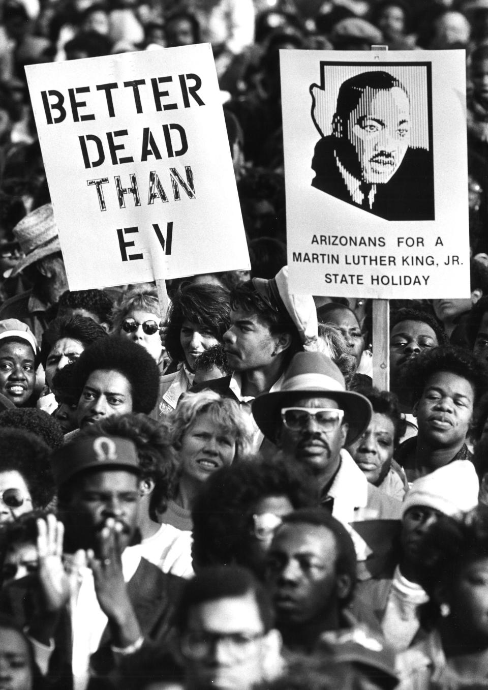 Demonstrators march in Phoenix on Jan. 19, 1987, to show their support for making Martin Luther King Jr. Day an official state holiday in Arizona.